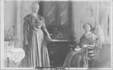 SA1708.49 - Photo shows two sisters at a desk and table., Winterthur Shaker Photograph and Post Card Collection 1851 to 1921c